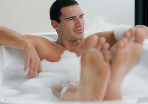 A man bathes with baking soda to enlarge his penis